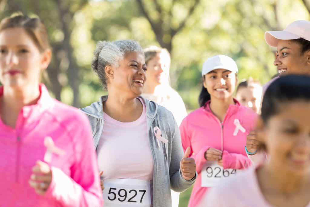 Cheerful senior woman and her daughter during charity walk