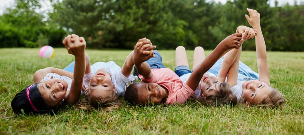 Group of children outside holding hands