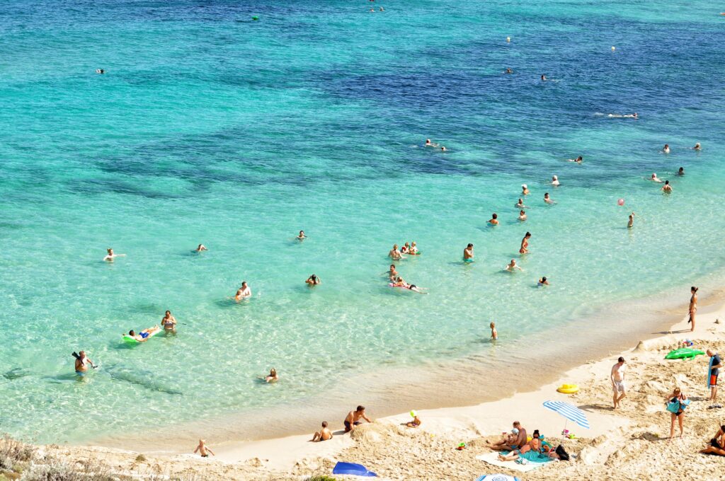 People on the beach and swimming in the water