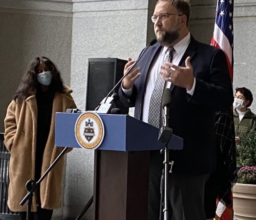photo of man speaking at a podium at public event