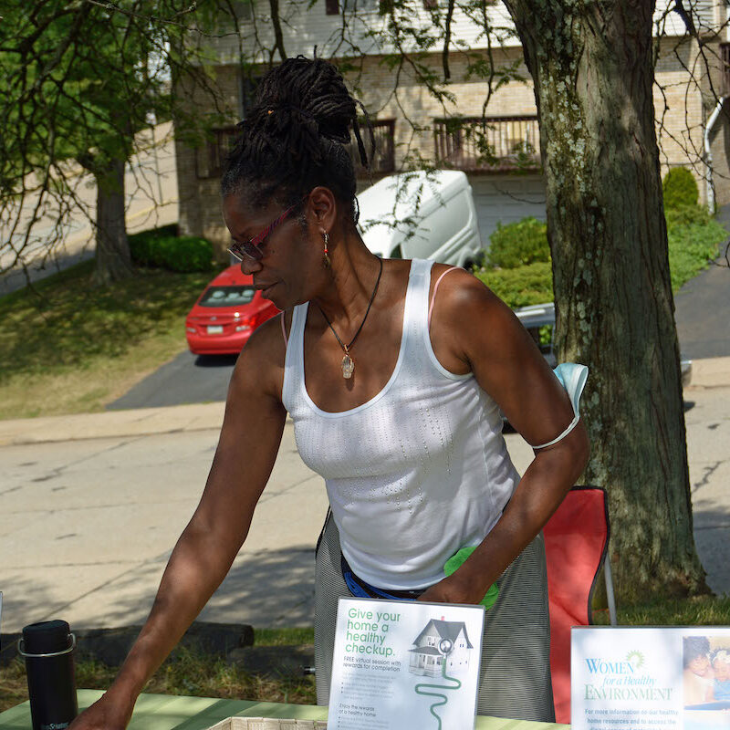 photo of woman distributing pamphlets at resource fair