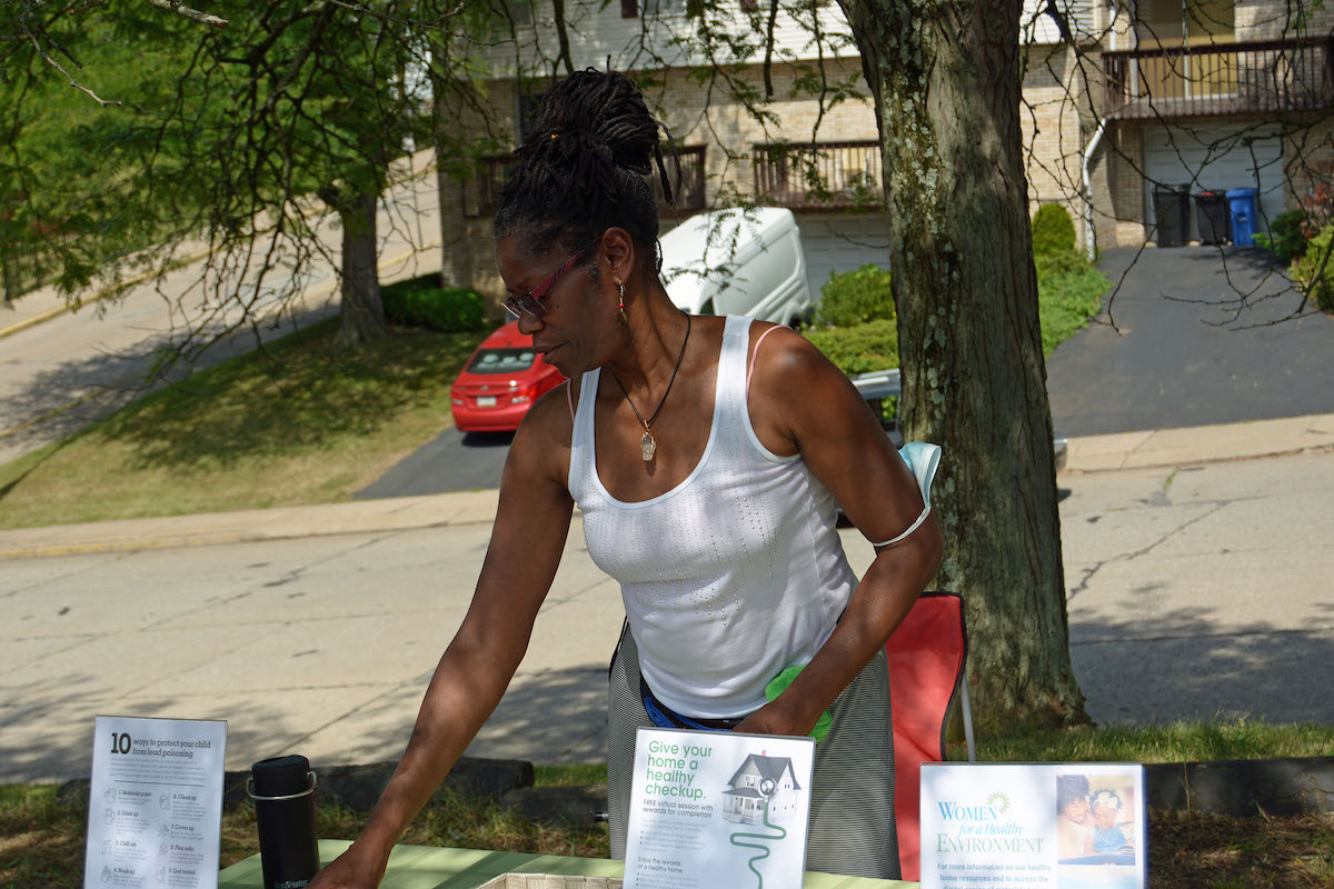 photo of woman distributing pamphlets at resource fair