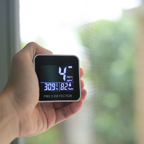 Image of a hand holding an air quality test