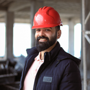 A contractor wearing a red hard hat, smiling